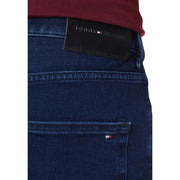 Dark blue denim jeans made from organic cotton featuring a black tommy hilfiger waistband label and signature logo
