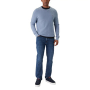 Light blue tommy hilfiger crewneck sweater with black ribbed collar paired with blue organic cotton slim fit jeans