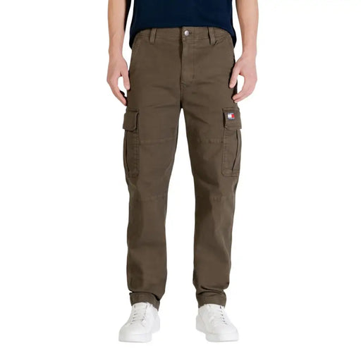 Olive green tommy hilfiger men jeans made from organic cotton featuring cargo pants with multiple pockets and logo patch