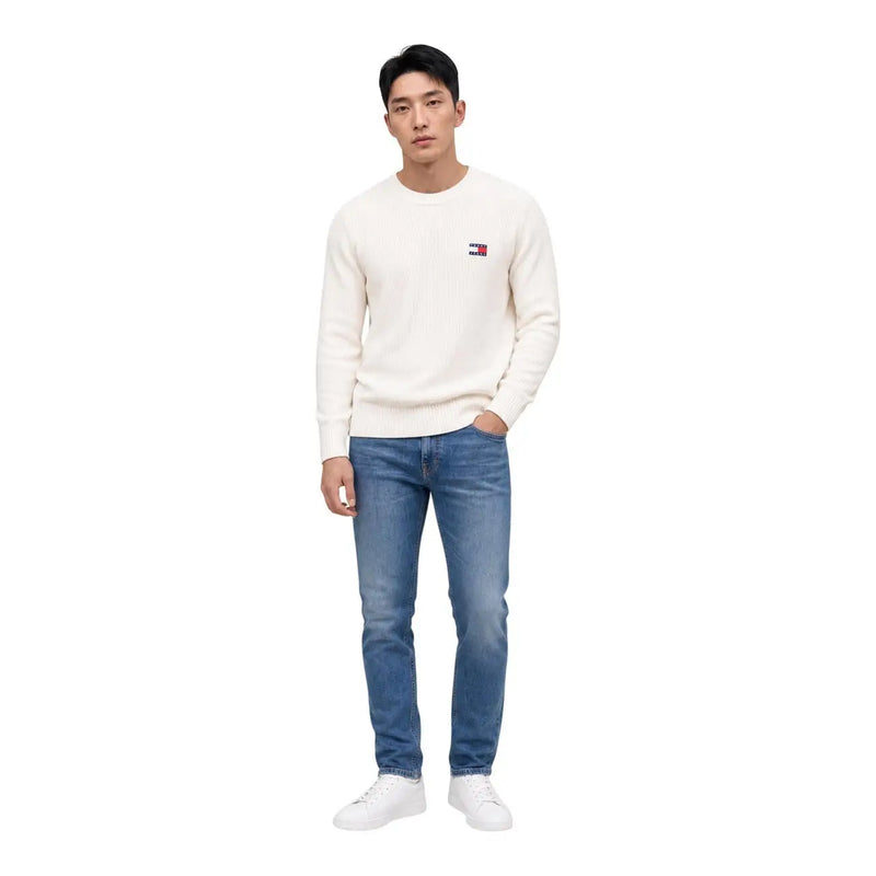 A cream-colored tommy hilfiger organic cotton crewneck sweater with a small embroidered logo on the left chest