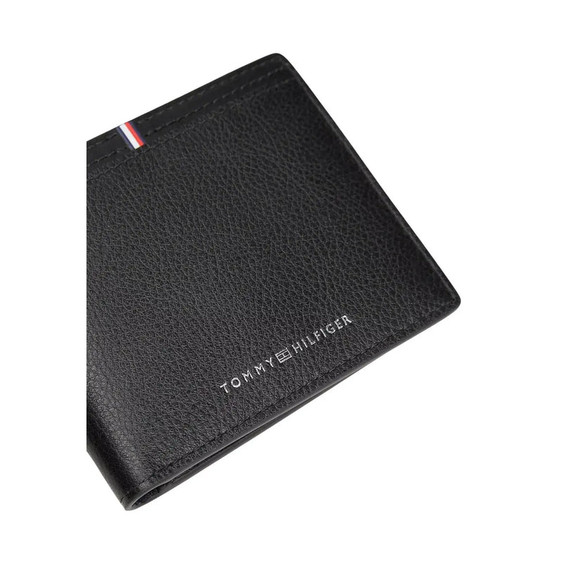 Tommy Hilfiger men wallet black textured leather with silver logo and red white blue striped tab visible on front side