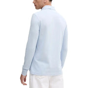 Light blue polo shirt with white trim and collar, made of cotton.