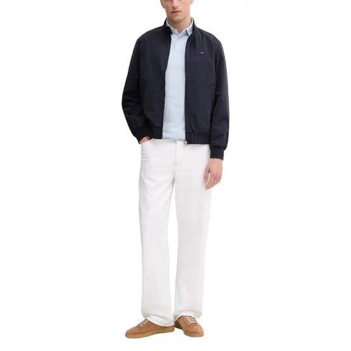 Navy blue bomber jacket with black accents and a tommy hilfiger logo.