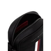 Tommy Hilfiger men metro mini reporter bag black with zipper opening showing red interior lining and signature logo