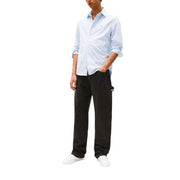 Light blue and white striped button-down shirt with rolled-up sleeves paired with Tommy Hilfiger men organic cotton stretch black jeans trousers