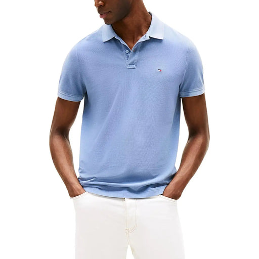 Light blue Tommy Hilfiger men polo shirt with classic collar, button placket, short sleeves, and cotton fabric