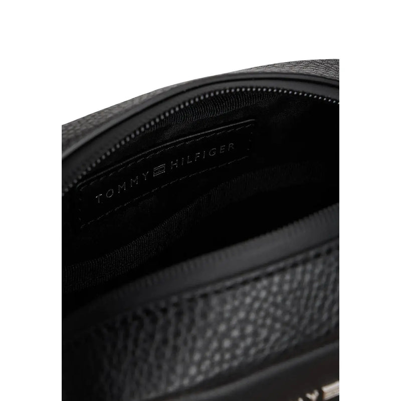 Black textured leather tommy hilfiger crossbody bag with subtle embossed logo on interior lining polyurethane material