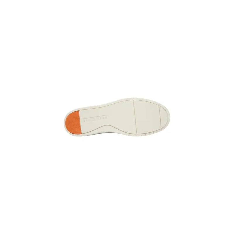 White rubber shoe sole with vibrant orange heel tab shown from the back of tommy hilfiger men suede moccasin camel shoes