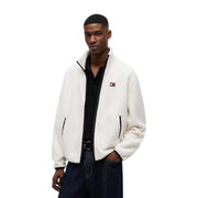 White fluffy fleece jacket with black zipper and trim featuring tommy hilfiger logo on left chest in polyester