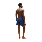 Navy blue Tommy Hilfiger men swimwear swim trunks with a small logo on the waistband for casual beachwear