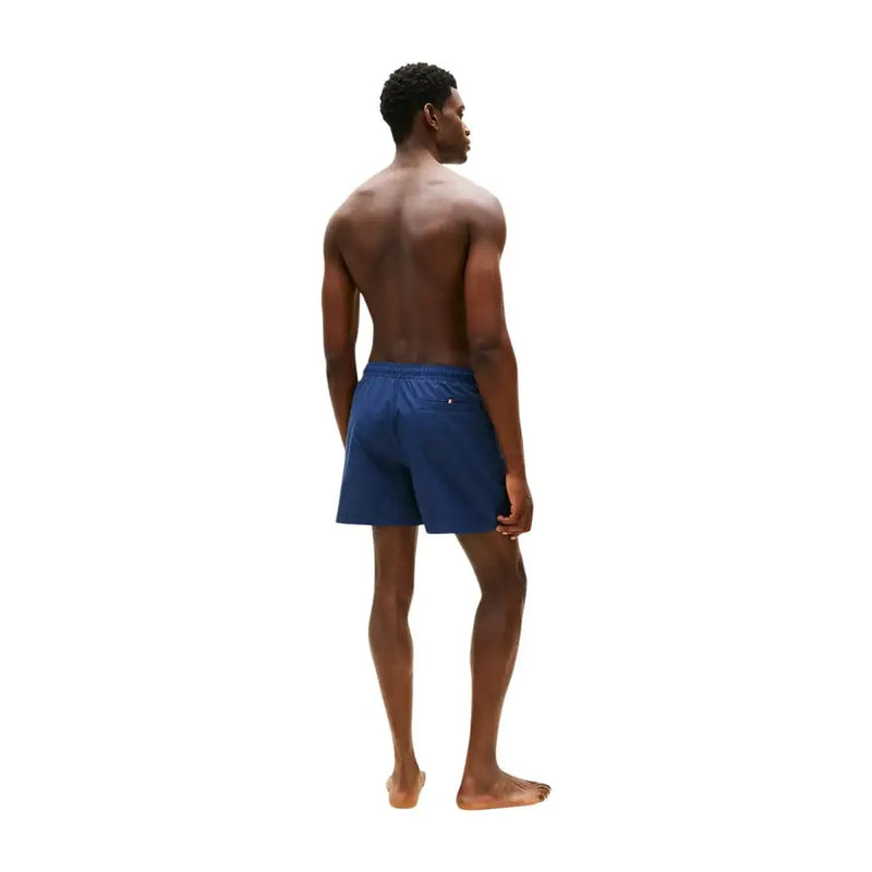 Navy blue Tommy Hilfiger men swimwear swim trunks with a small logo on the waistband for casual beachwear