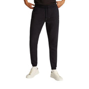 Black slim cotton fleece joggers by Tommy Hilfiger with drawstring waistband and ribbed cuffs made from soft fleece material