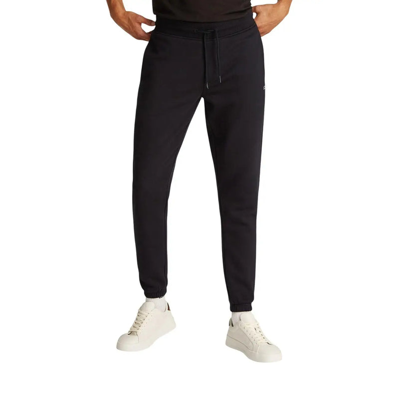 Black slim cotton fleece joggers by Tommy Hilfiger with drawstring waistband and ribbed cuffs made from soft fleece material