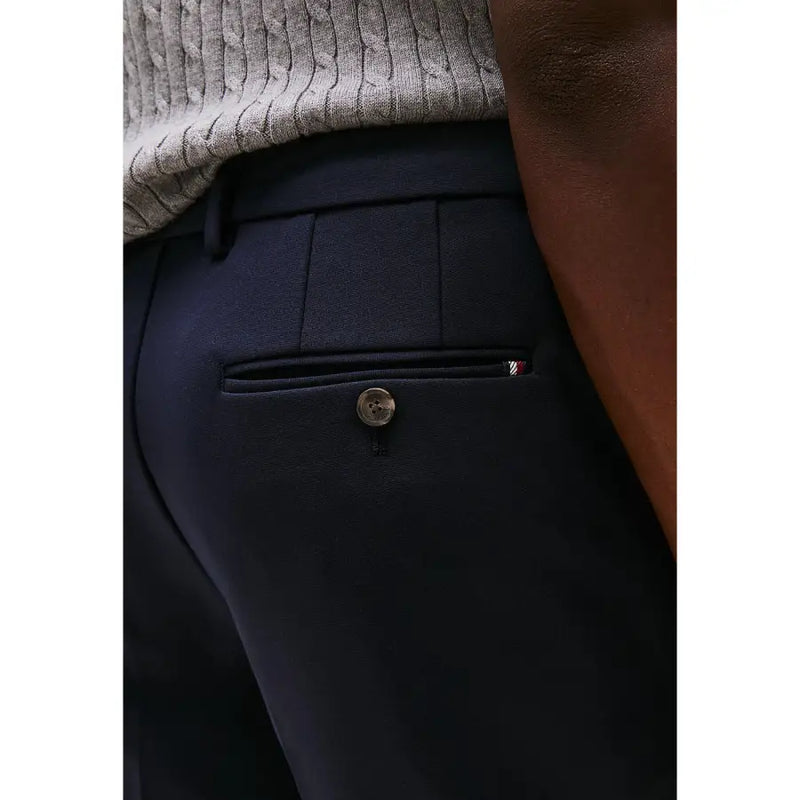 Navy blue tailored Tommy Hilfiger men trousers with subtle textured weave and branded tab on the back pocket