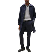 Navy blue wool overcoat with button closures and classic collar featured with Tommy Hilfiger men trousers