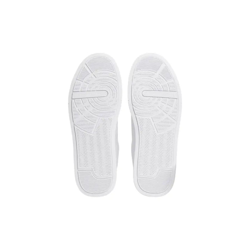 White rubber soles with textured circular tread and subtle geometric lines on tommy hilfiger men white leather sneakers