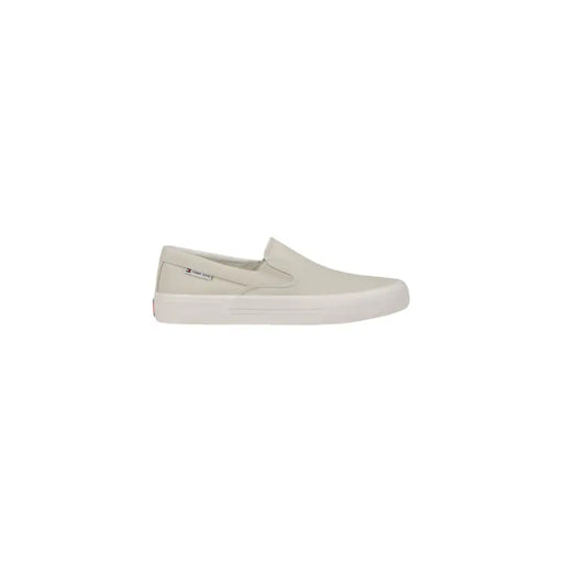 Back view of tommy hilfiger men’s beige slip-on sneakers in cotton canvas with white rubber sole and subtle heel branding