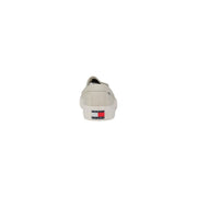 Back view of tommy hilfiger men’s beige slip on cotton sneakers with classic logo patch on the heel