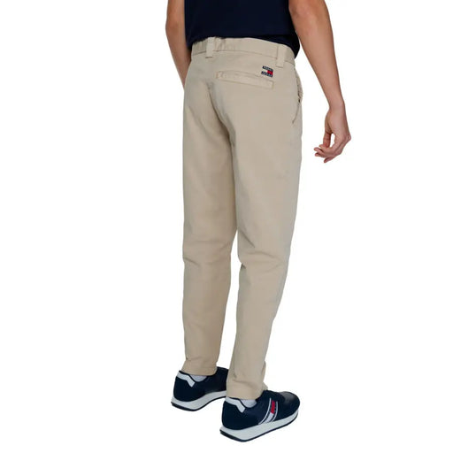 Men’s beige chino pants with small flag logo on back pocket from Tommy Hilfiger Fall Winter collection
