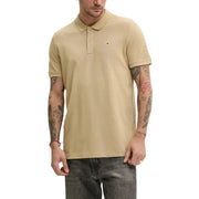 Beige Tommy Hilfiger men’s polo shirt with classic collar and logo on chest for summer wear