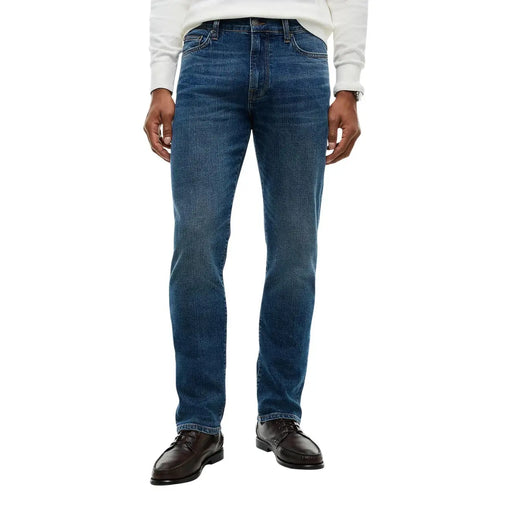 Tommy Hilfiger slim fit jeans for men in faded blue denim with subtle whiskering, front view