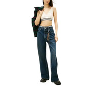 Tommy Hilfiger white sleeveless v neck knit top paired with high-waisted dark blue straight-leg denim jeans with keychain