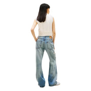 Tommy Hilfiger women denim jeans in light blue organic cotton with flared legs and distressed detail on right thigh