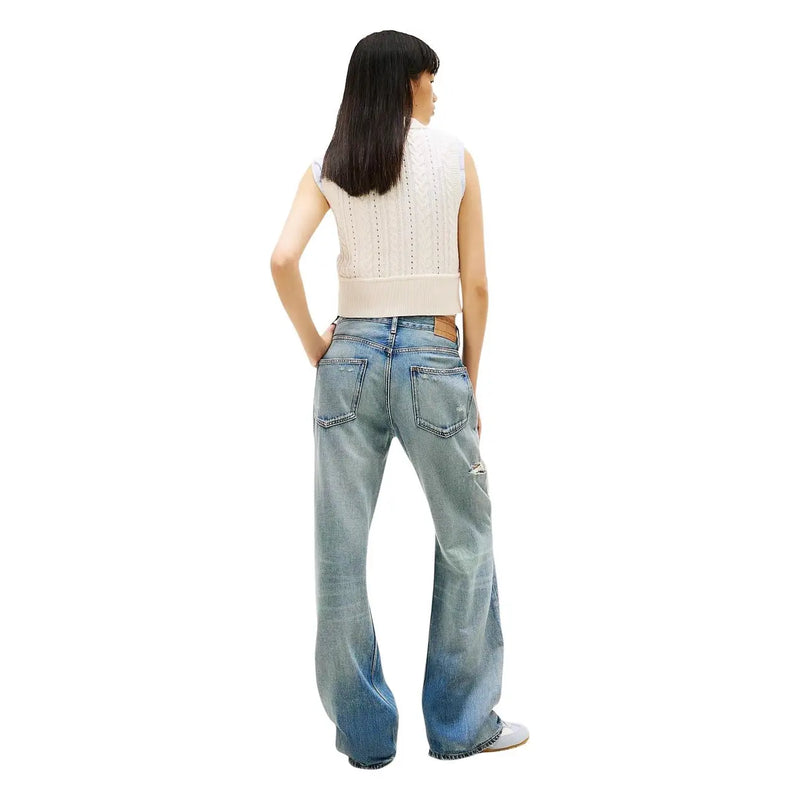 Tommy Hilfiger women denim jeans in light blue organic cotton with flared legs and distressed detail on right thigh