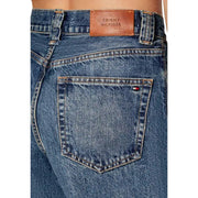 Blue denim tommy hilfiger women jeans showing the back with brown leather brand patch and flag logo on pocket