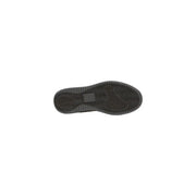 Black rubber shoe sole with textured wavy tread and rectangular label on the back side of tommy hilfiger women sneakers white suede laces