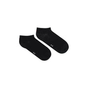 Black cotton Tommy Hilfiger women ankle socks with subtle white text and a faint pattern near the heel back side