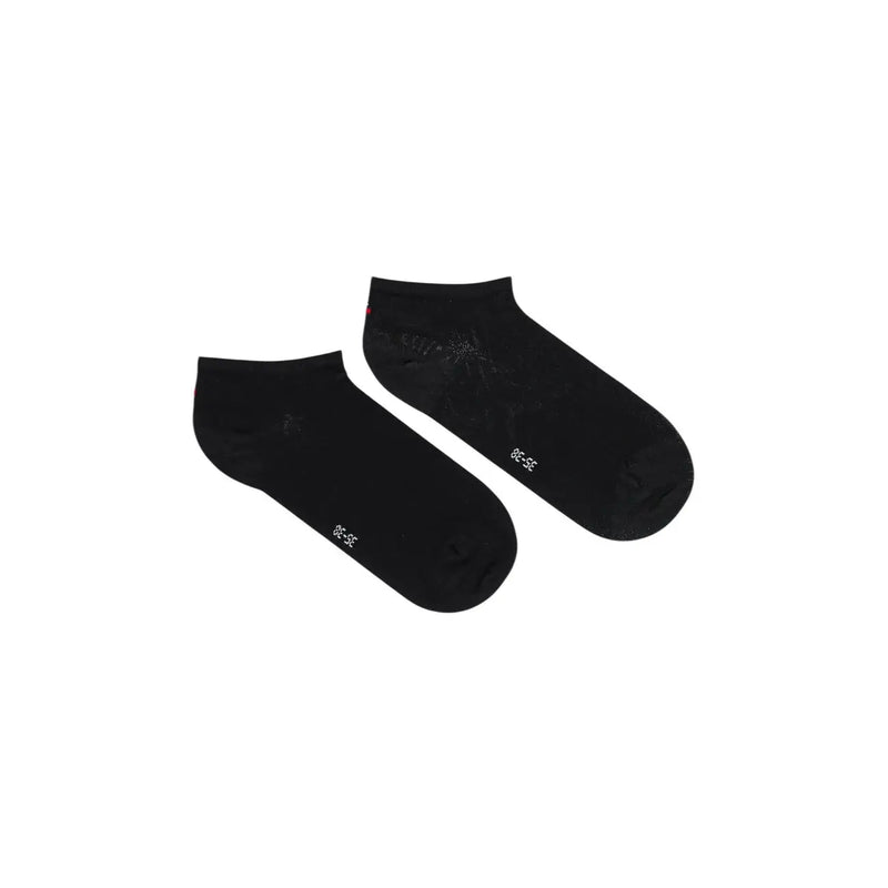 Black cotton Tommy Hilfiger women ankle socks with subtle white text and a faint pattern near the heel back side