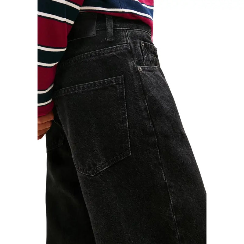 Tommy Hilfiger women’s black organic cotton jeans with a faded worn-in look and classic stitching details
