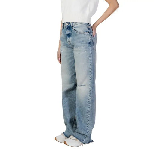High-waisted light blue faded wash distressed denim jeans made from organic cotton by Tommy Hilfiger for women