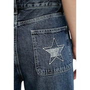 Back side of tommy hilfiger women’s dark-wash blue organic cotton jeans with white embroidered star patch on pocket