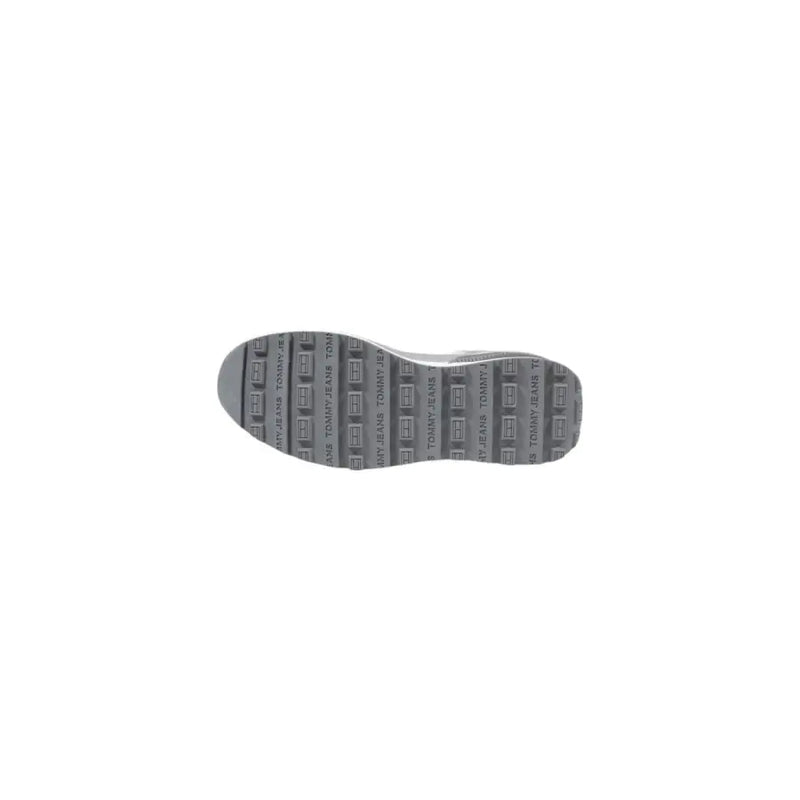 Gray rubber sole with repeating tommy jeans logo pattern on tommy hilfiger women’s grey leather sneakers