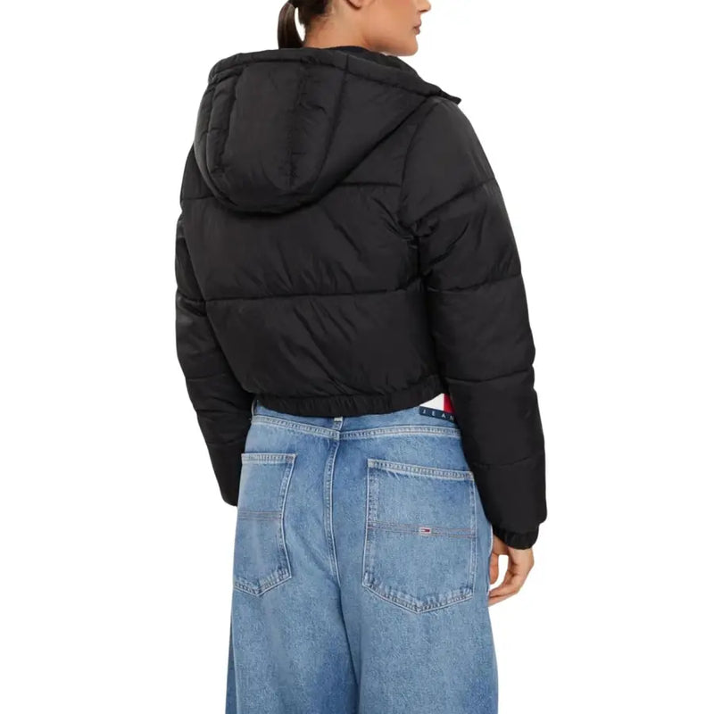 Black hooded puffer jacket with turtleneck paired with light-wash wide-leg jeans