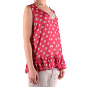 A vibrant pink sleeveless polyester tank top with cream polka dots and ruffled hem by Simona Barbieri