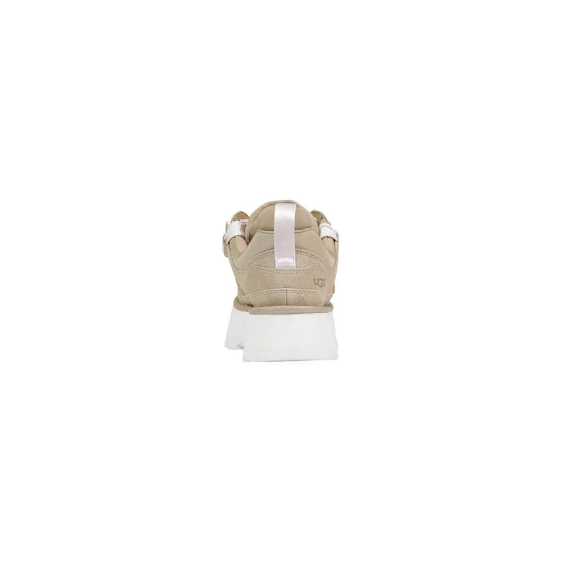 Ugg women beige leather platform boots featuring a beige ugg sneaker with white rubber sole and light pink pull tab