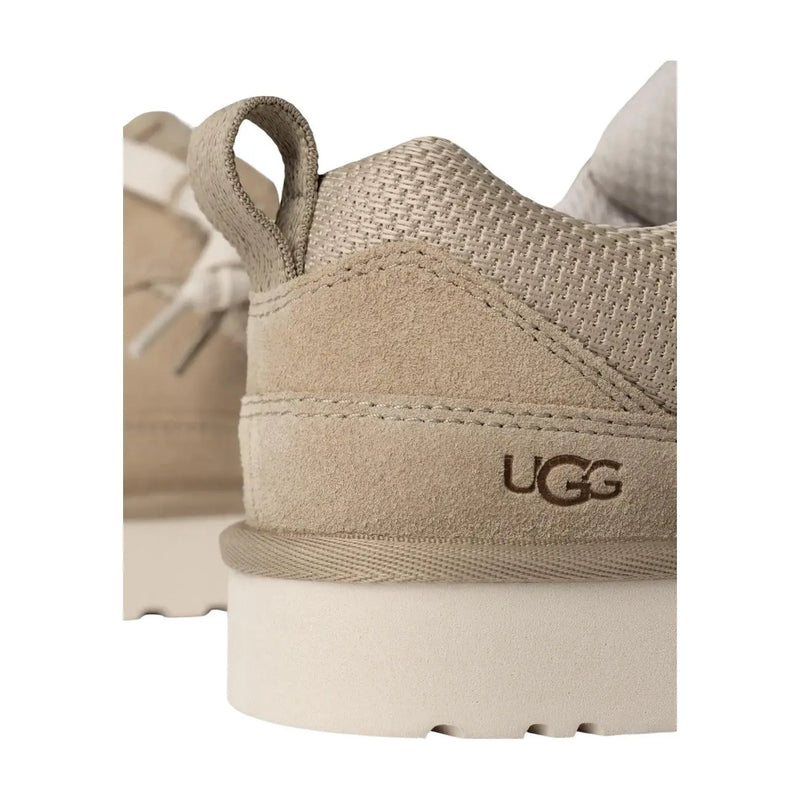 Beige ugg women suede lace up sneaker with suede and mesh upper featuring pull tab and embossed logo on the heel back side