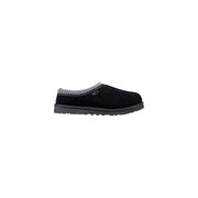 Black ugg slip-on moccasin with textured suede upper and white zigzag stitch, ideal for fall and winter comfort