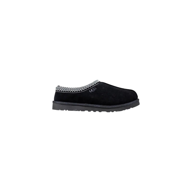 Black ugg slip-on moccasin with textured suede upper and white zigzag stitch, ideal for fall and winter comfort