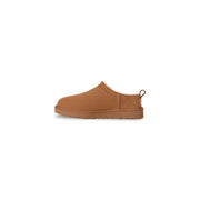Tan ugg women leather slip on shoe with soft plush interior and sturdy rubber sole for spring and summer wear