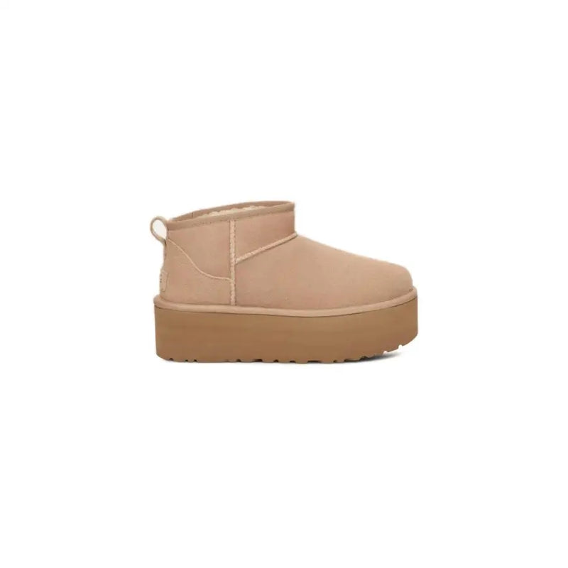 Ugg women’s beige suede ankle boot with platform sole and pull tab at the back from fall winter collection