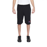 Young boy in urban style clothing, white T-shirt and Underclub men shorts