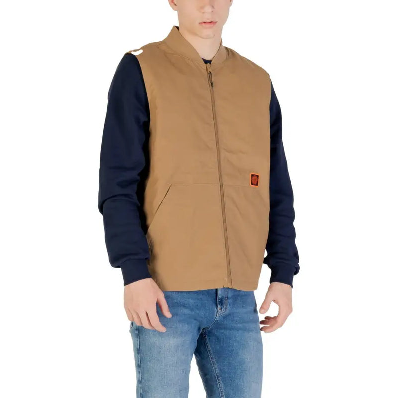 Brown bomber jacket with navy blue sleeves and red patch on sleeve.