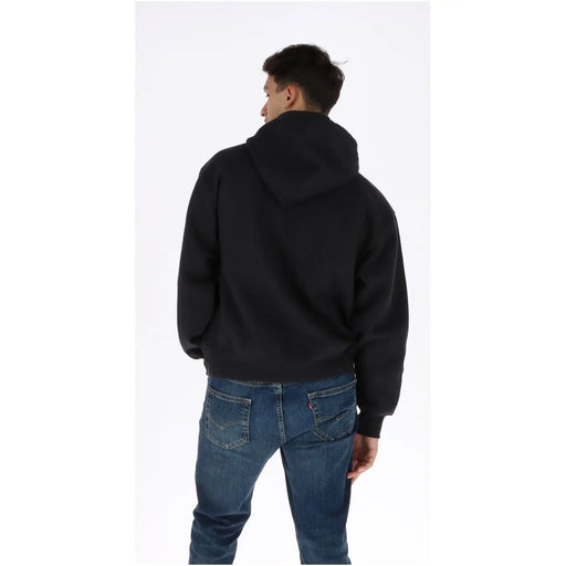 Sweat à capuche noir Vans pour homme en coton, coupe décontractée et douce, poignets côtelés noirs.