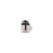 White vans men sneakers in suede with black accents and red logo on the heel shown from the back side