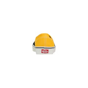 Bright yellow canvas slip-on vans men sneakers with black rubber sole white midsole and red logo on the heel back side