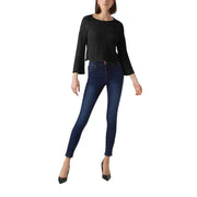 A pair of dark indigo cotton acrylic skinny jeans with five-pocket design and subtle fading at the thighs